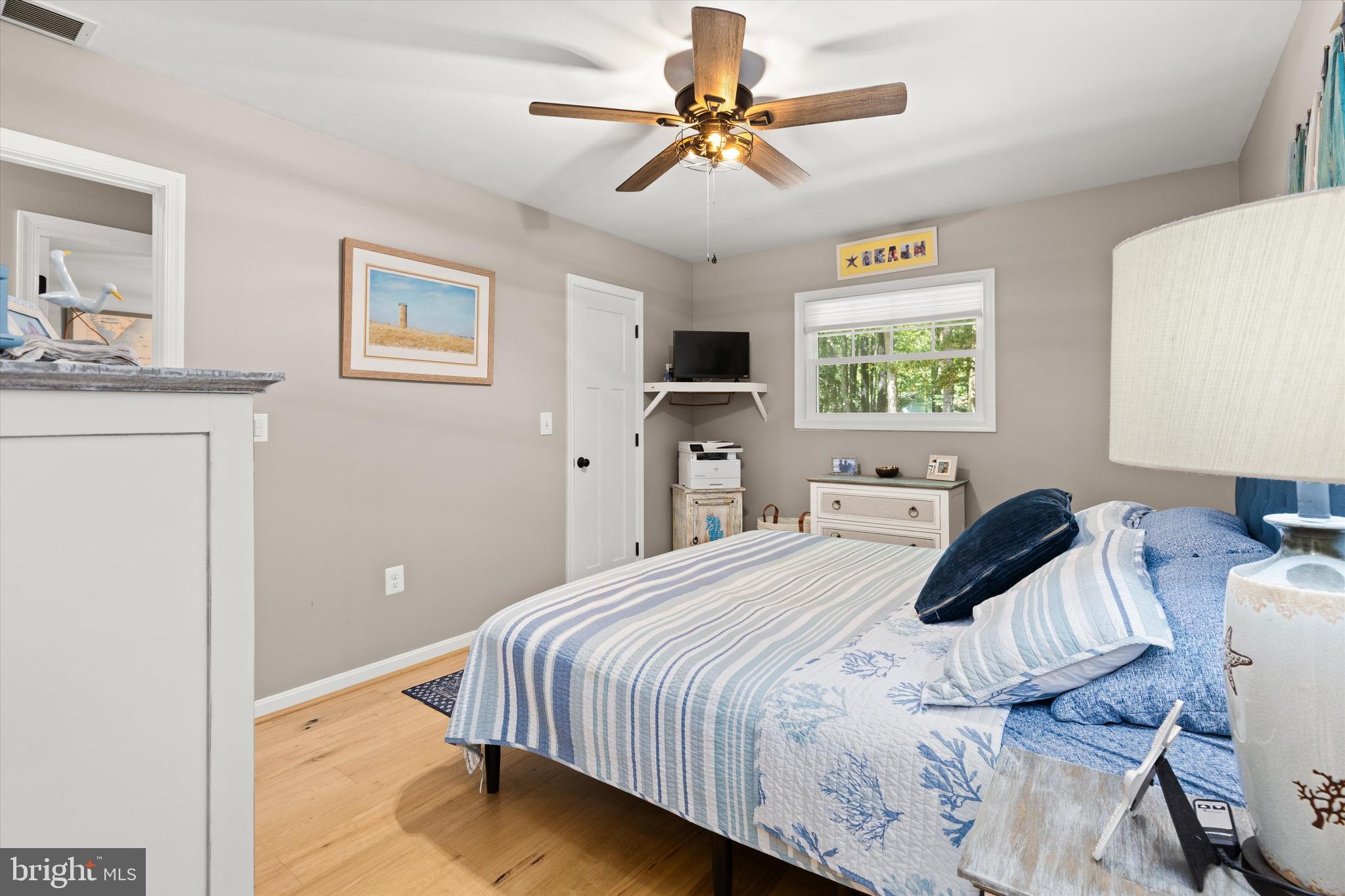 4 Haven End Ocean Pines, MD 21811 - Photo 20 of 37 a bedroom with a bed and a chandelier