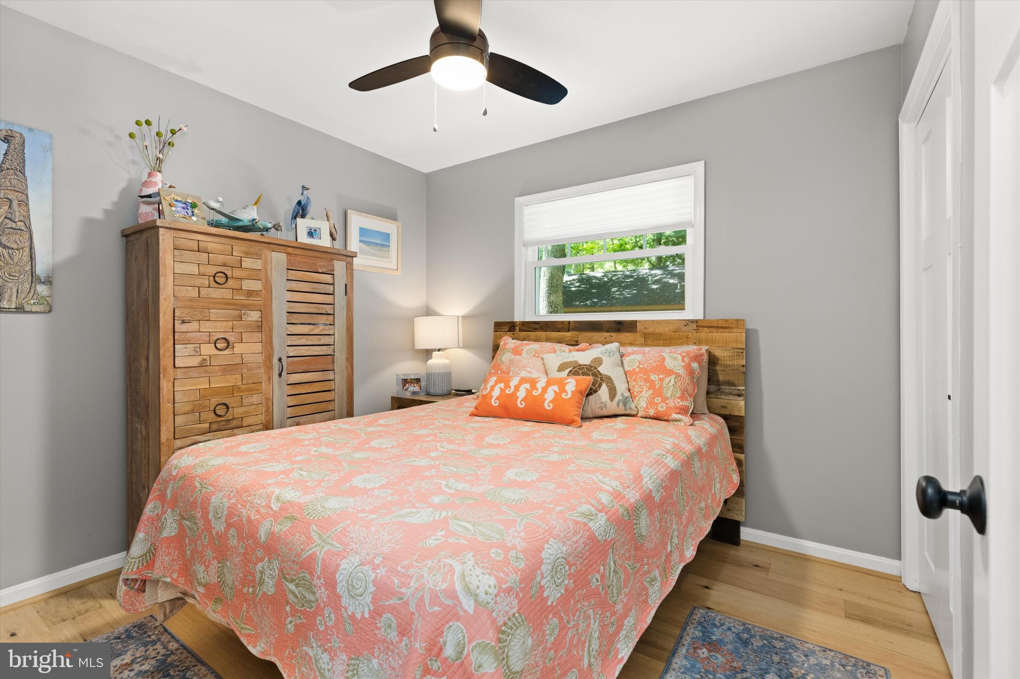 4 Haven End Ocean Pines, MD 21811 - Photo 23 of 37 a bedroom with a bed chandelier and a window