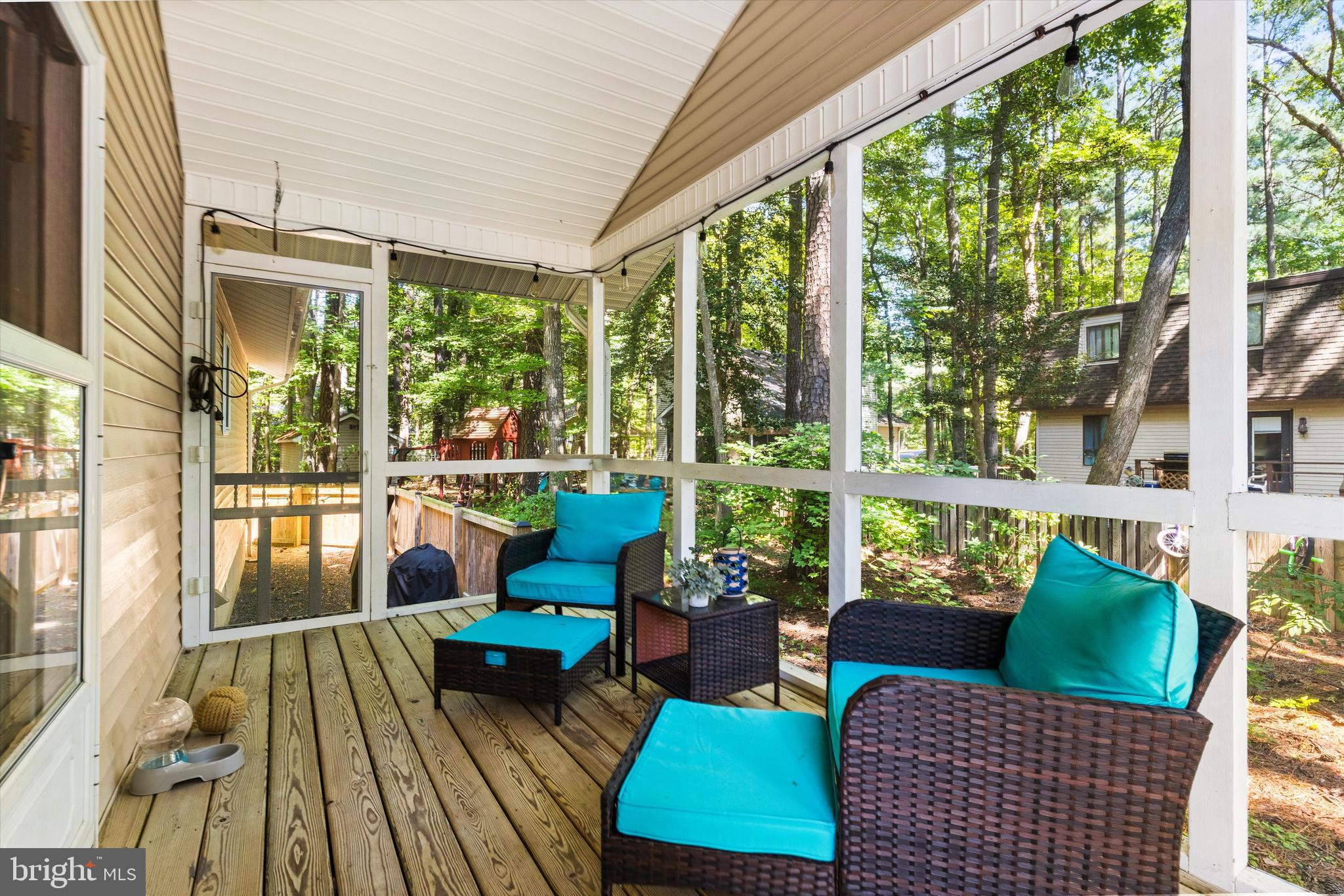 4 Haven End Ocean Pines, MD 21811 - Photo 28 of 37 a view of a patio with couches chairs dining table and chairs barbeque grill with a small yard and large trees