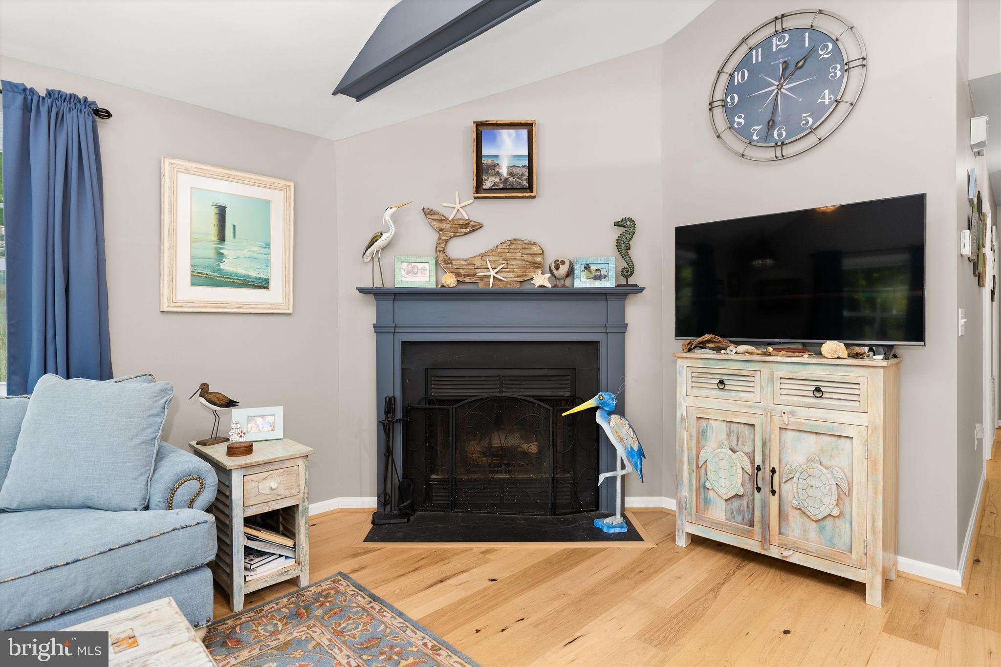 4 Haven End Ocean Pines, MD 21811 - Photo 9 of 37 a living room with furniture a flat screen tv and a fireplace