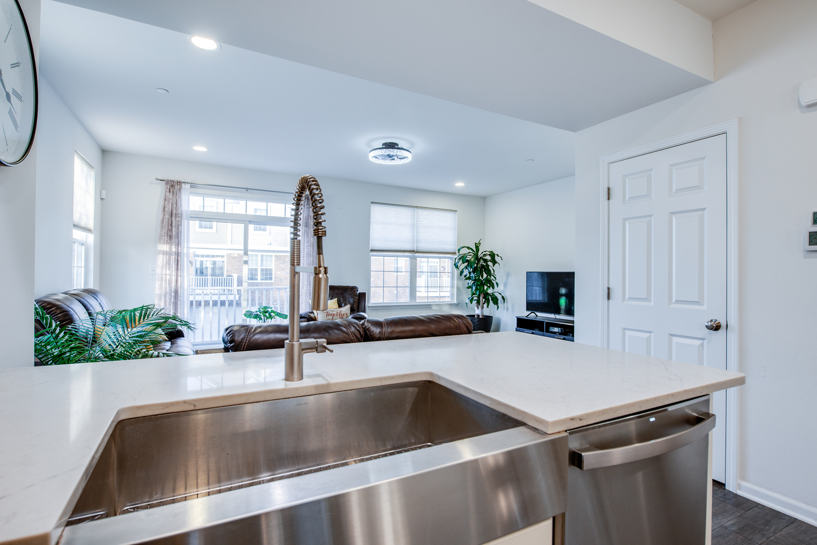 4477 Monroe Court Naperville, IL 60564 - Photo 9 of 23 a kitchen with a sink a counter top space and living room