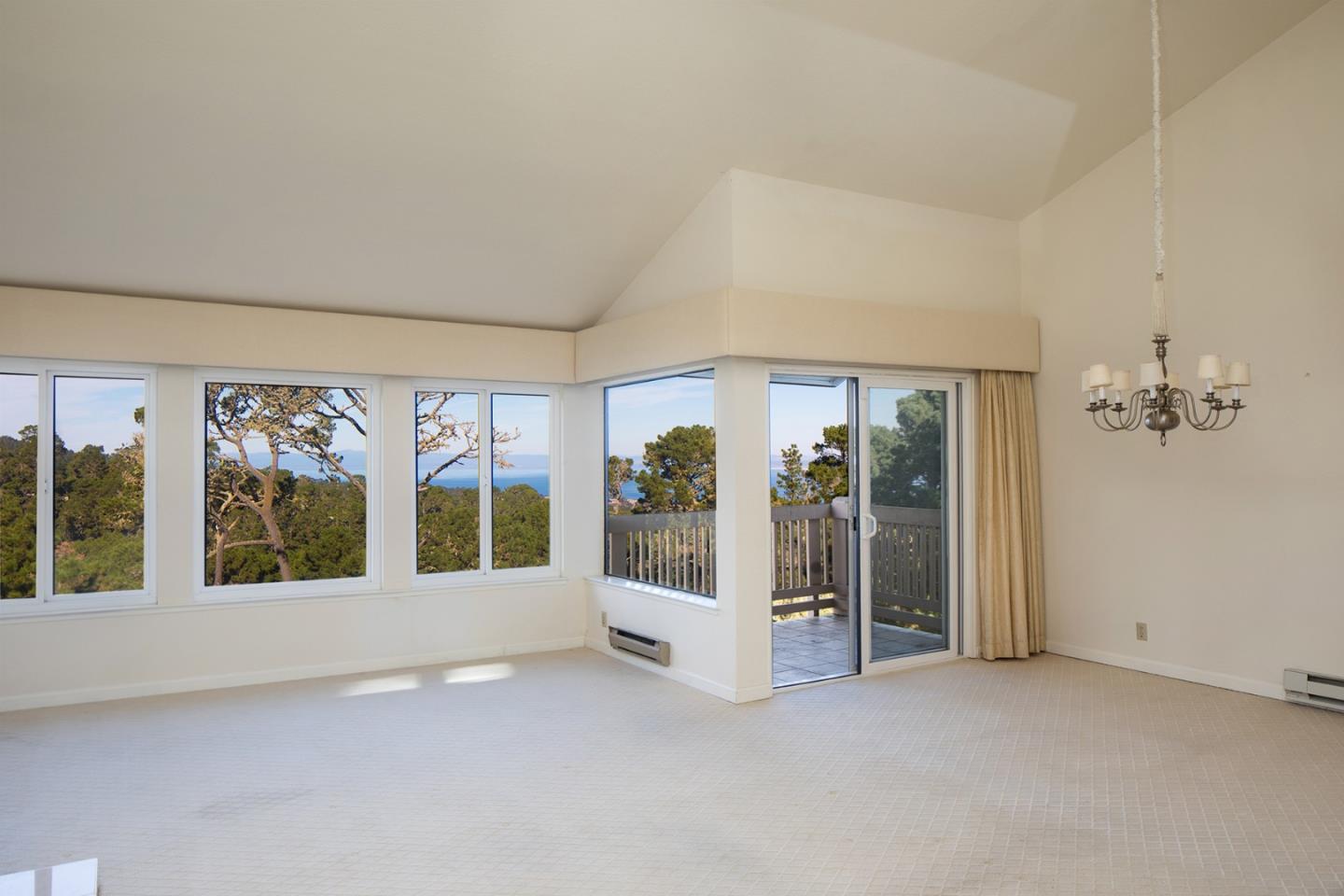 27 Shepherds Knoll Road, Unit 27 Monterey, CA 93940 - Photo 4 of 11 an empty room with a large window and front door
