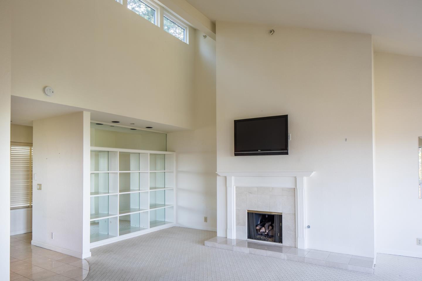 27 Shepherds Knoll Road, Unit 27 Monterey, CA 93940 - Photo 5 of 11 a living room with a fireplace and a flat screen tv