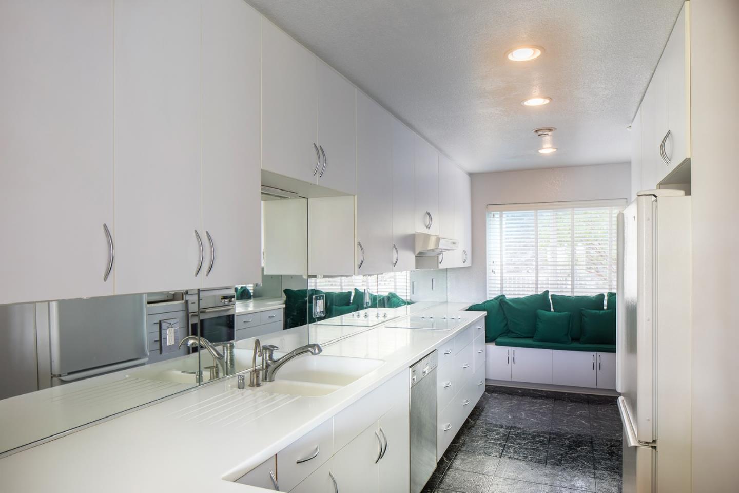 27 Shepherds Knoll Road, Unit 27 Monterey, CA 93940 - Photo 7 of 11 a large white kitchen with a large window and sink