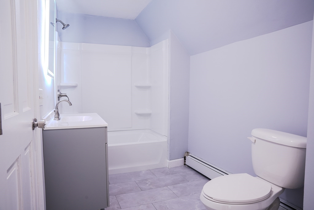 32 Dale Street Franklin, MA 02038 - Photo 9 of 11 a white toilet sitting next to a bath tub