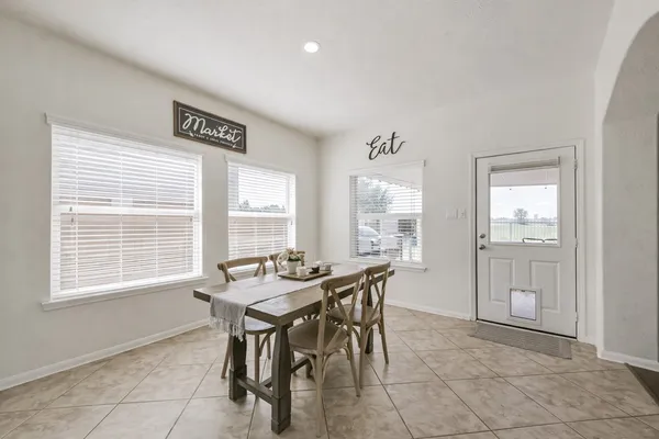 a dining room with furniture and window