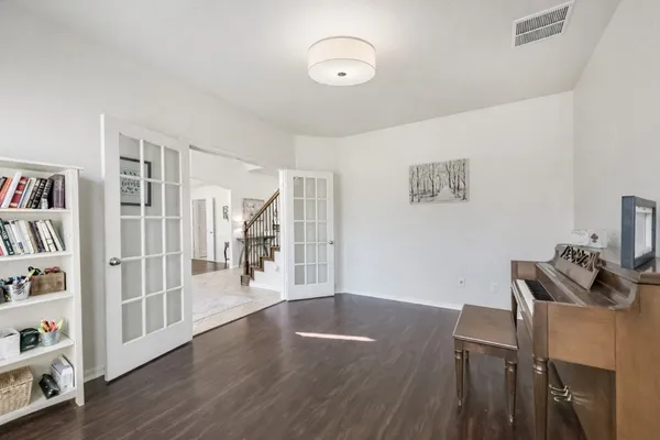 a view of a livingroom with furniture and an empty room
