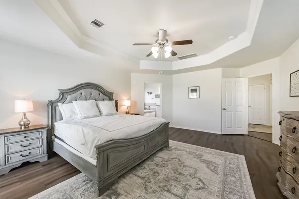 a bedroom with a bed and a chandelier