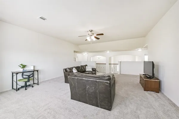 a view of a kitchen with furniture and a ceiling fan