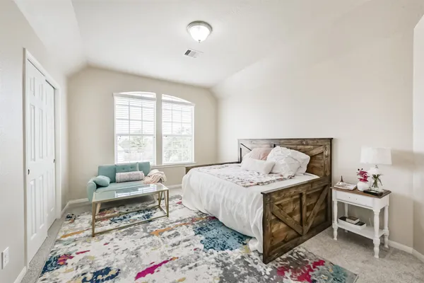 a bedroom with a bed and a couch
