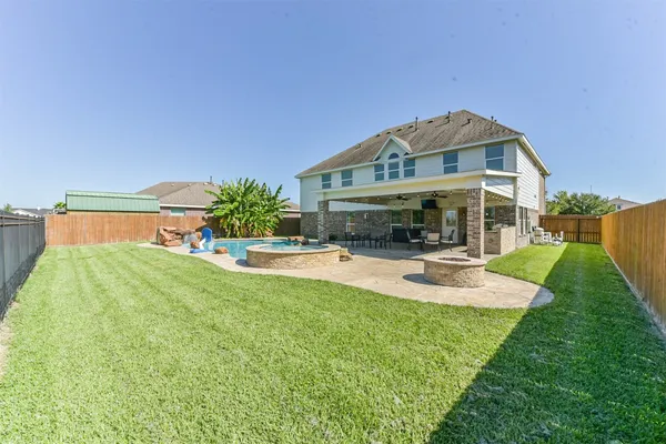 a view of a house with swimming pool and sitting area