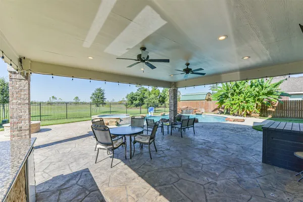 a view of a patio with a table chairs and a backyard