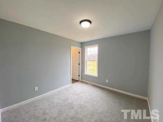 151 Mamie Road Benson, NC 27504 - Photo 25 of 33 a view of an empty room with a window