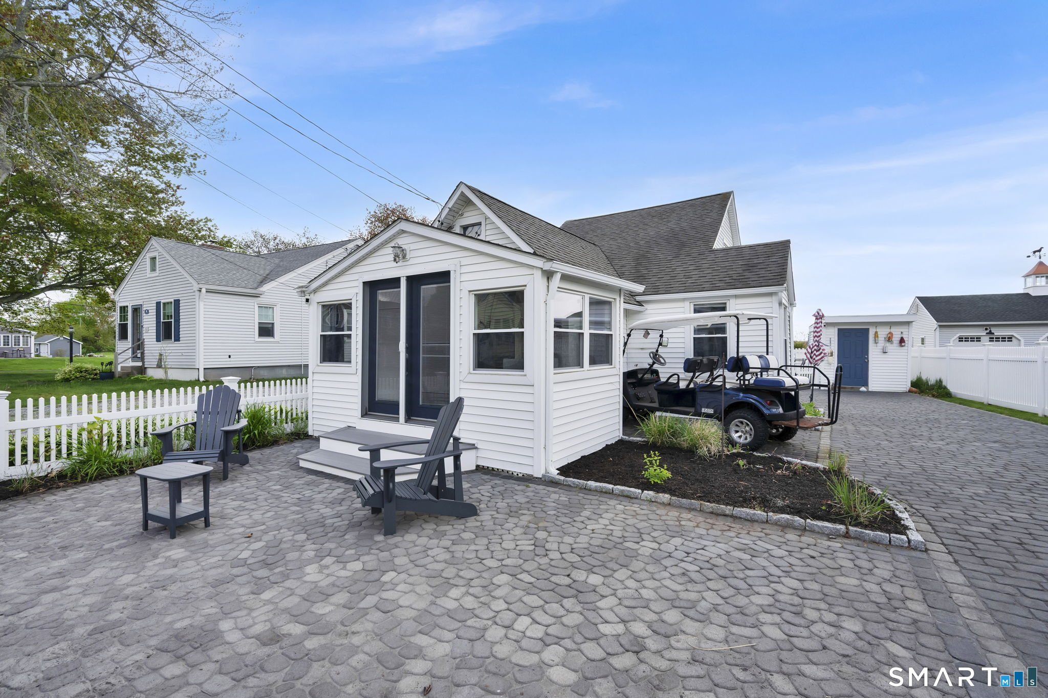 96 Chalker Beach Road Old Saybrook, CT 06475 - Photo 1 of 33 a view of a house with a bench in patio