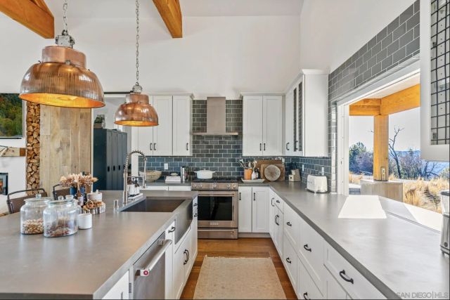 a living room with furniture fireplace and a large window
