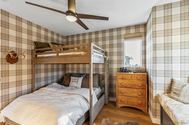 a bathroom with a granite countertop sink mirror vanity and toilet