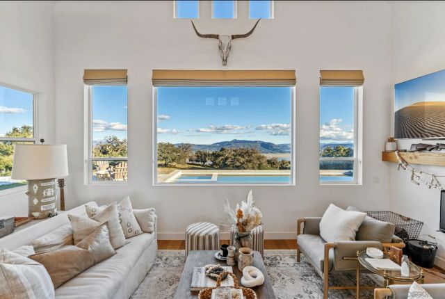 a dining room with furniture a chandelier and window