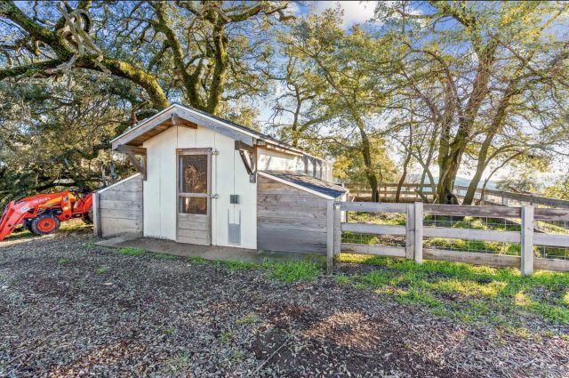 a outdoor space with patio the couches and a fireplace with the potted plants