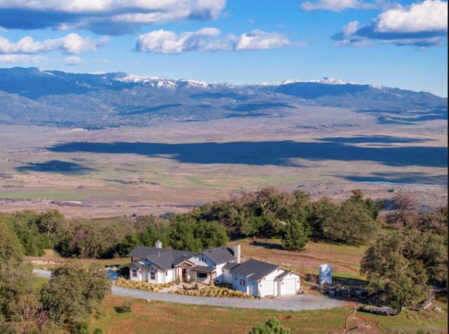 an aerial view of a house with a ocean view