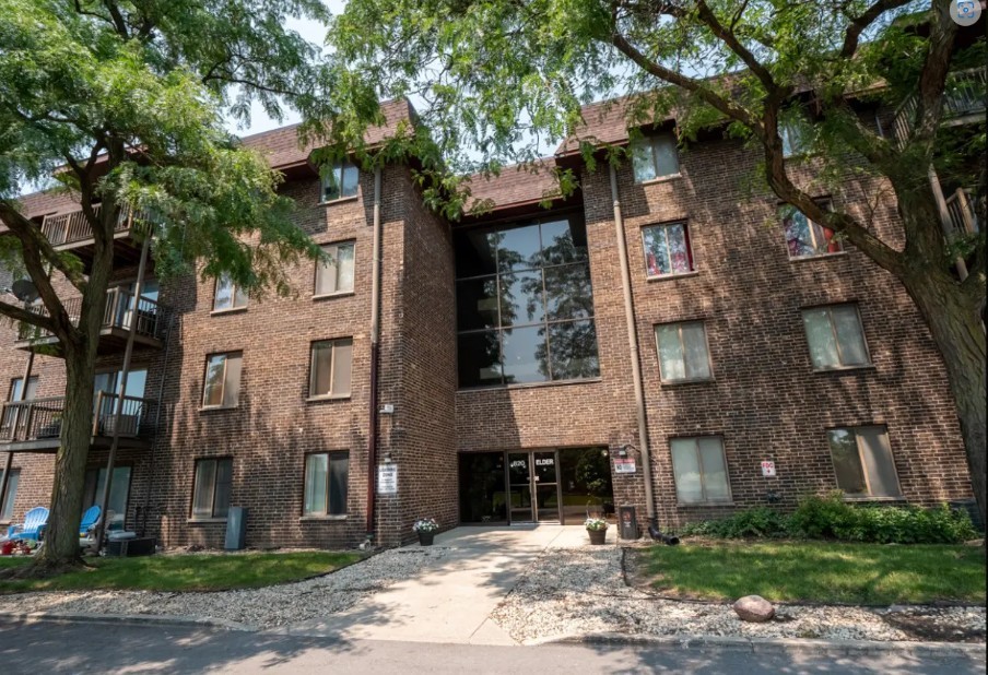 a front view of a building with garden
