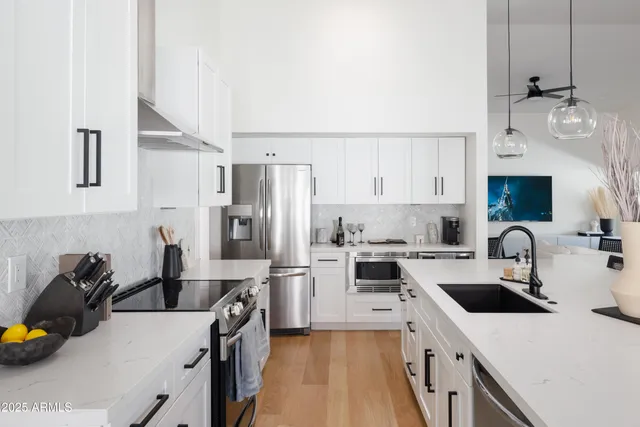 a kitchen with a sink a stove and refrigerator