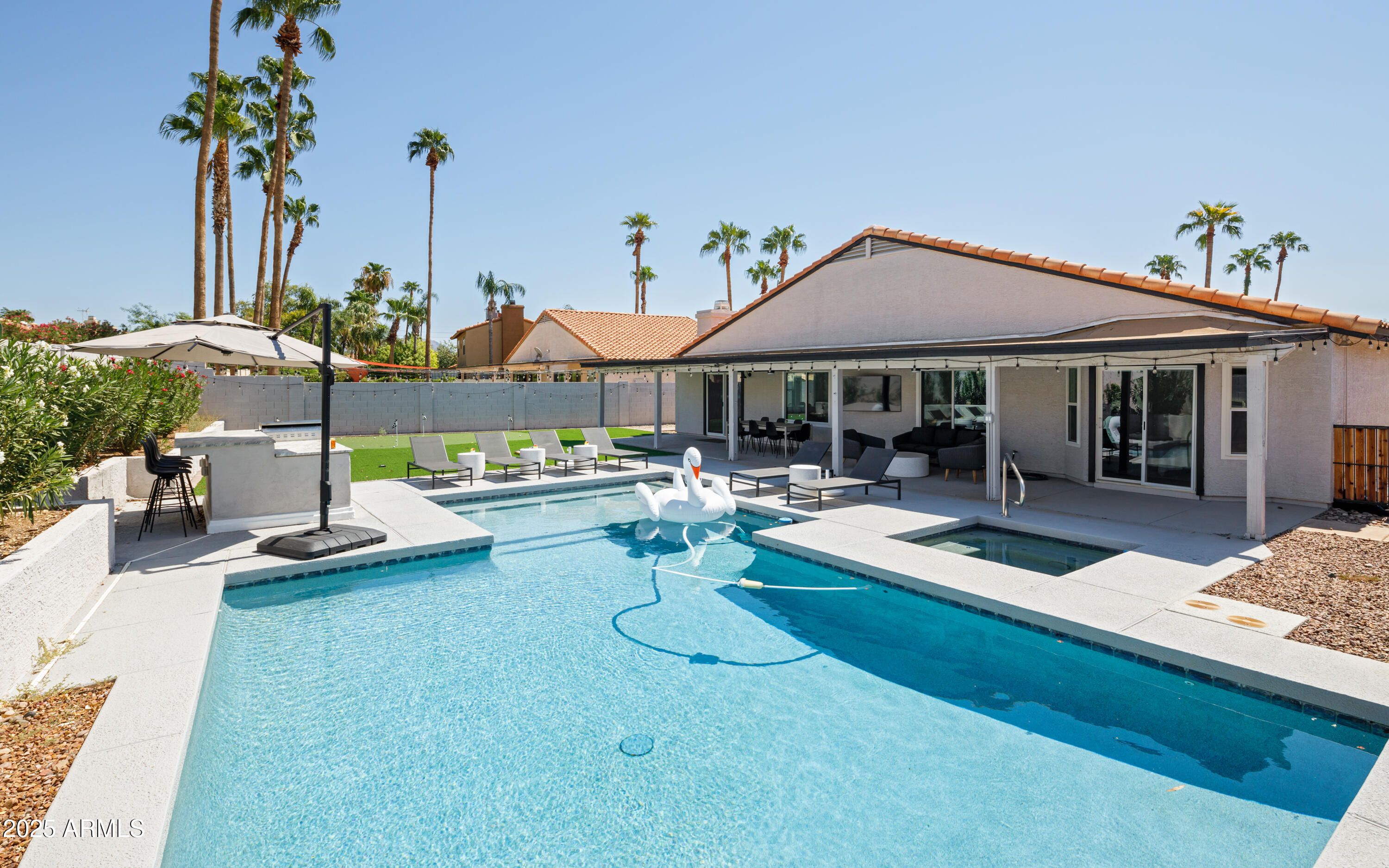 5502 East Grandview Road Scottsdale, AZ 85254 - Photo 2 of 42 a view of a house with swimming pool and sitting area
