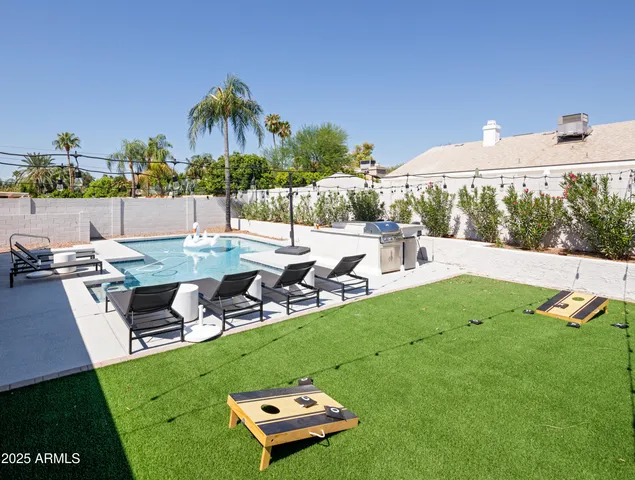 a view of a backyard with sitting area