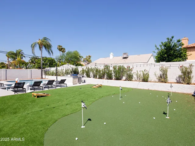 a view of a swimming pool and lounge chairs
