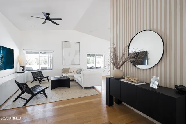 a living room with furniture a rug and a chandelier