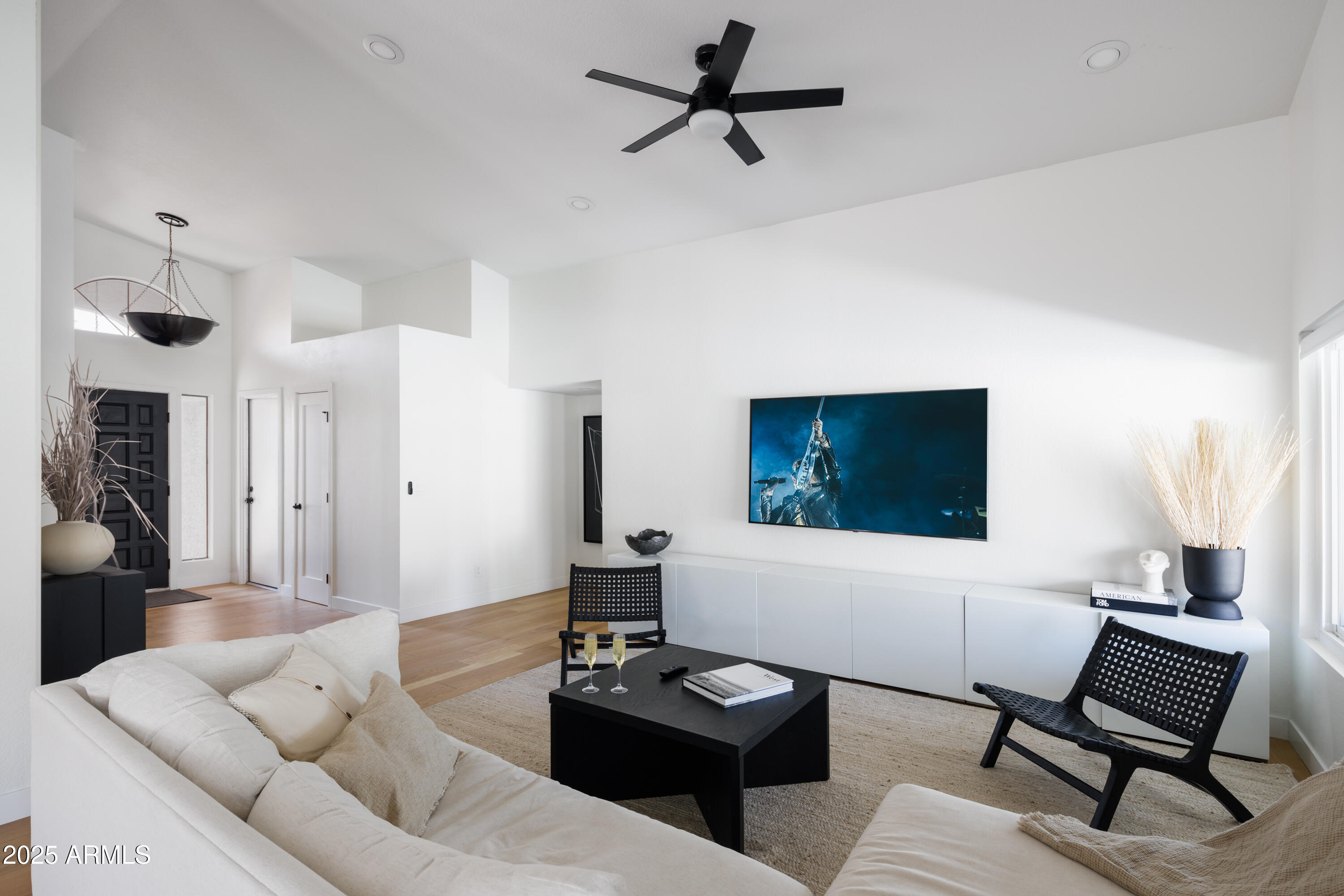 5502 East Grandview Road Scottsdale, AZ 85254 - Photo 9 of 42 a living room with furniture and a flat screen tv