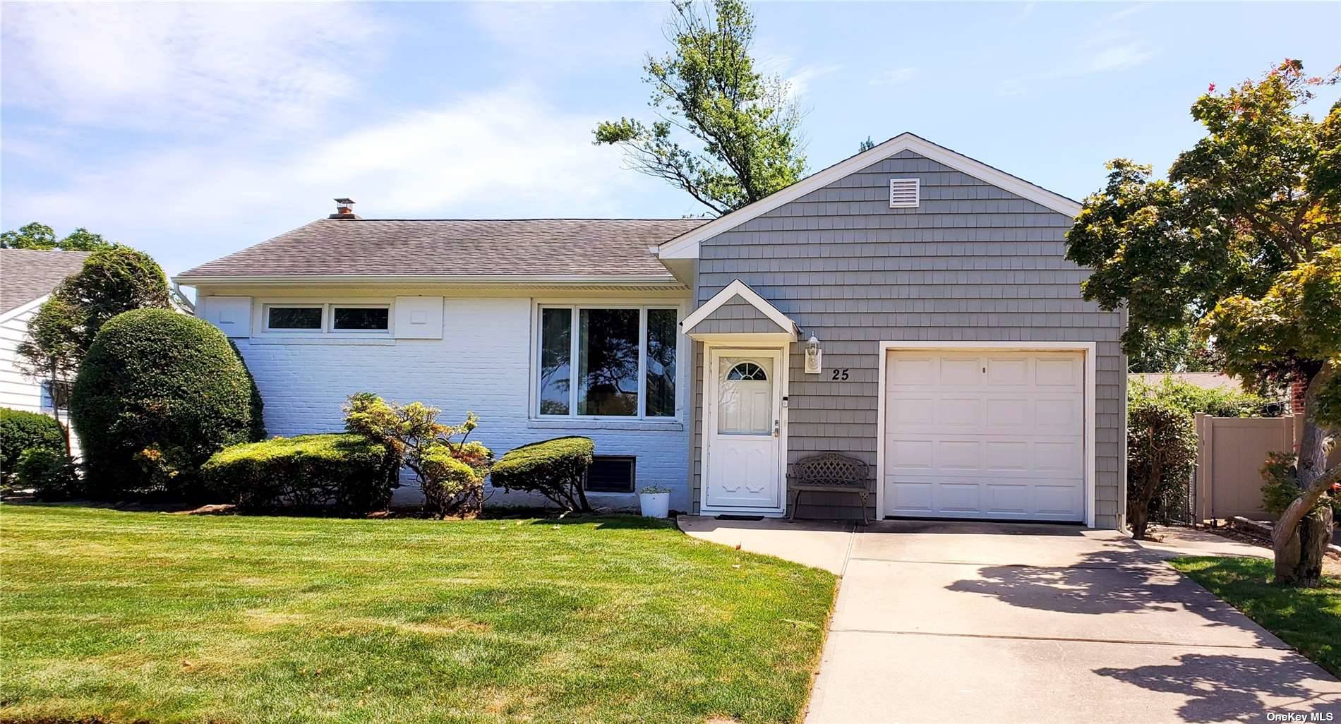 25 Forest Road Valley Stream, NY 11581 - Photo 1 of 1 a front view of a house with a yard