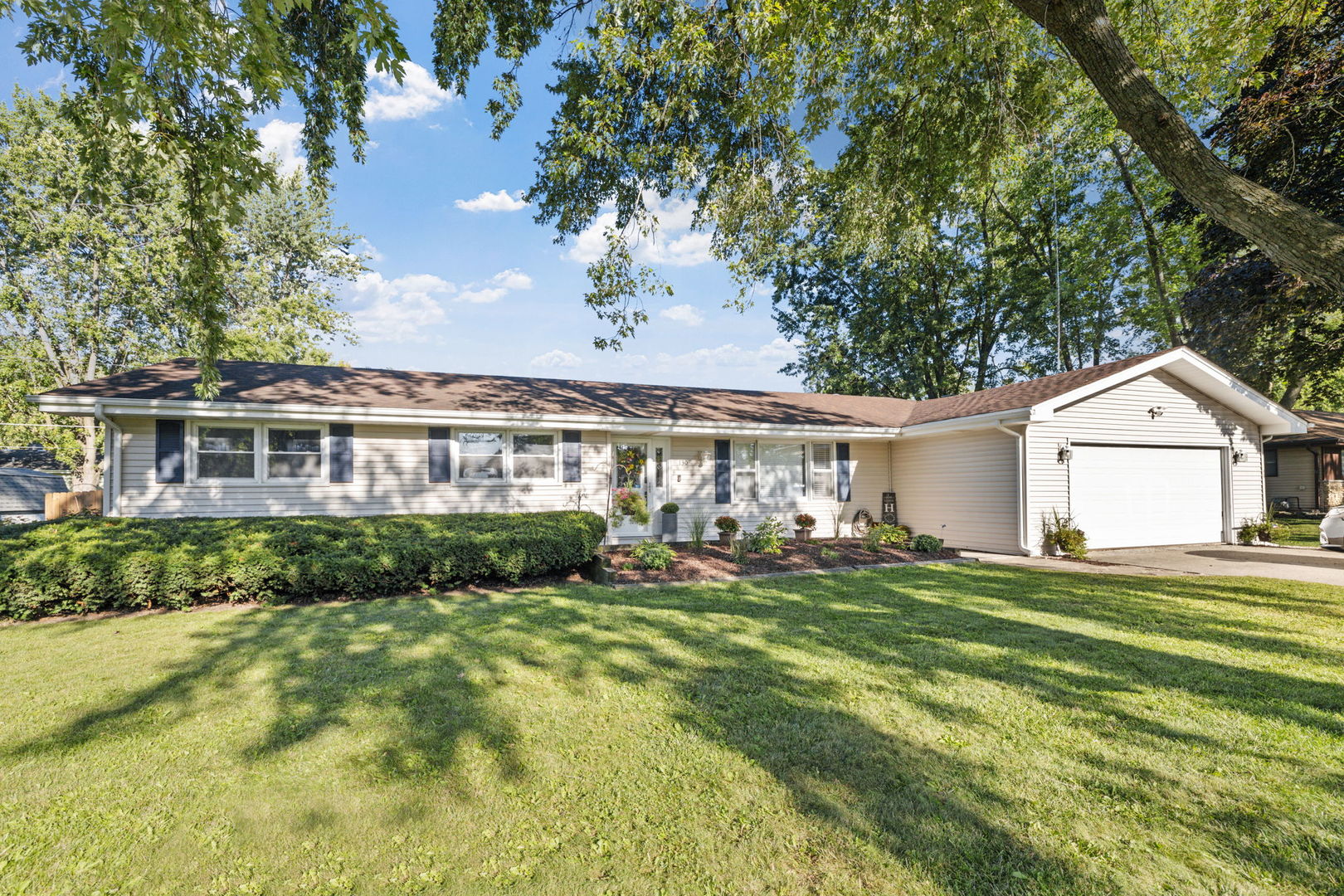 a front view of a house with a garden