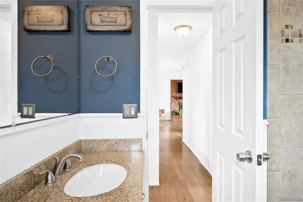 a bathroom with a sink a mirror and a shower