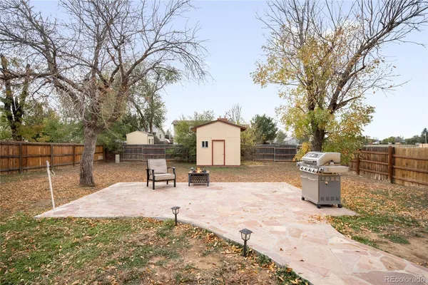 a backyard of a house with table and chairs