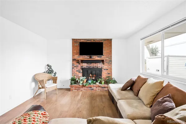 a living room with furniture a flat screen tv and a fireplace