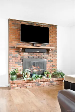 a living room with a flat screen tv and a fireplace