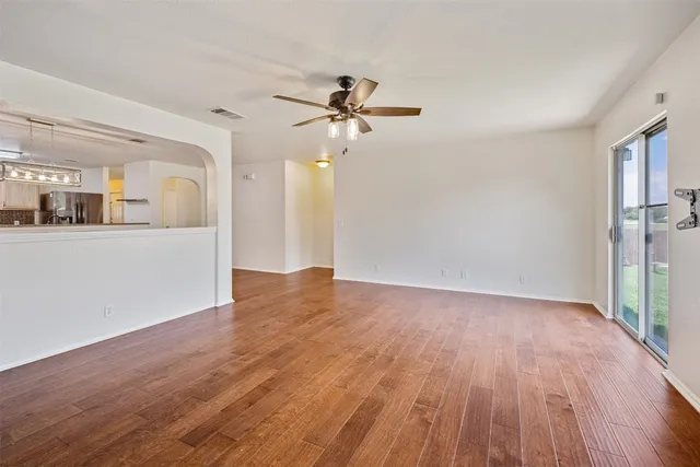 wooden floor in an empty room with a window