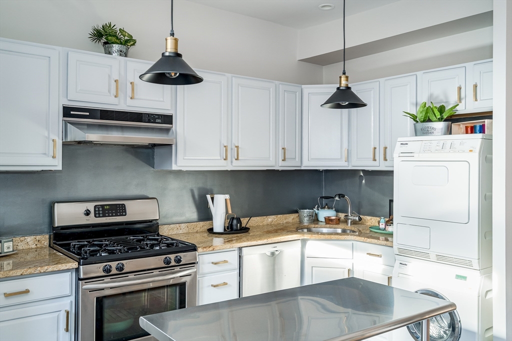 705 Massachusetts Avenue, Unit 6 Boston, MA 02118 - Photo 2 of 14 a kitchen with stainless steel appliances granite countertop a sink a stove and a refrigerator