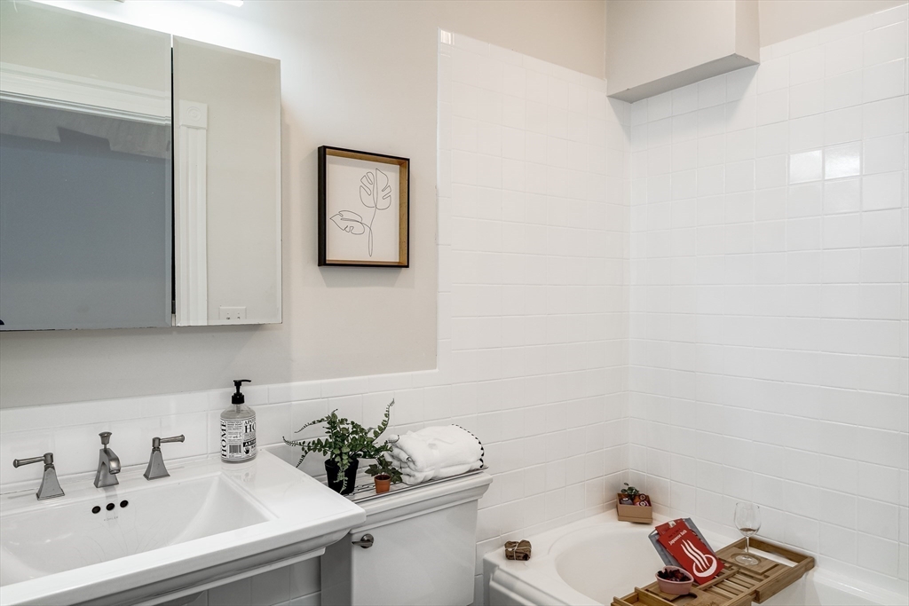705 Massachusetts Avenue, Unit 6 Boston, MA 02118 - Photo 5 of 14 a bathroom with a sink and a bathtub