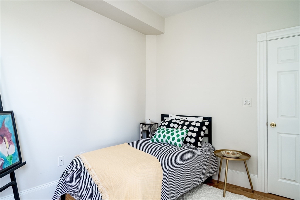 705 Massachusetts Avenue, Unit 6 Boston, MA 02118 - Photo 8 of 14 a bedroom with a bed and window