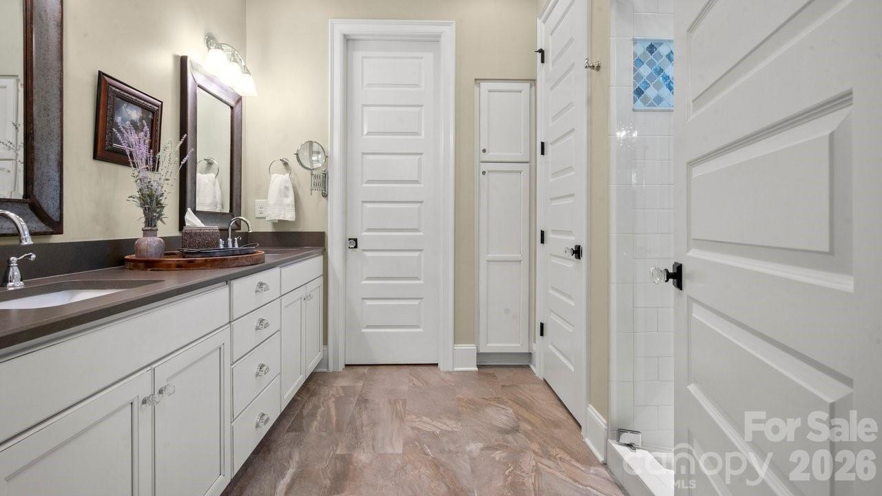 4854 Looking Glass Trail Denver, NC 28037 - Photo 37 of 48 a bathroom with a double vanity sink and mirror
