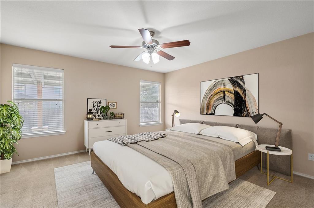 20224 Merlin Falcon Trail Pflugerville, TX 78660 - Photo 27 of 40 Relax in this well-lit bedroom featuring a ceiling fan and generous natural light from multiple windows.