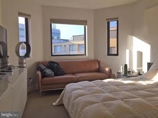 a living room with couches a mirror and painted walls
