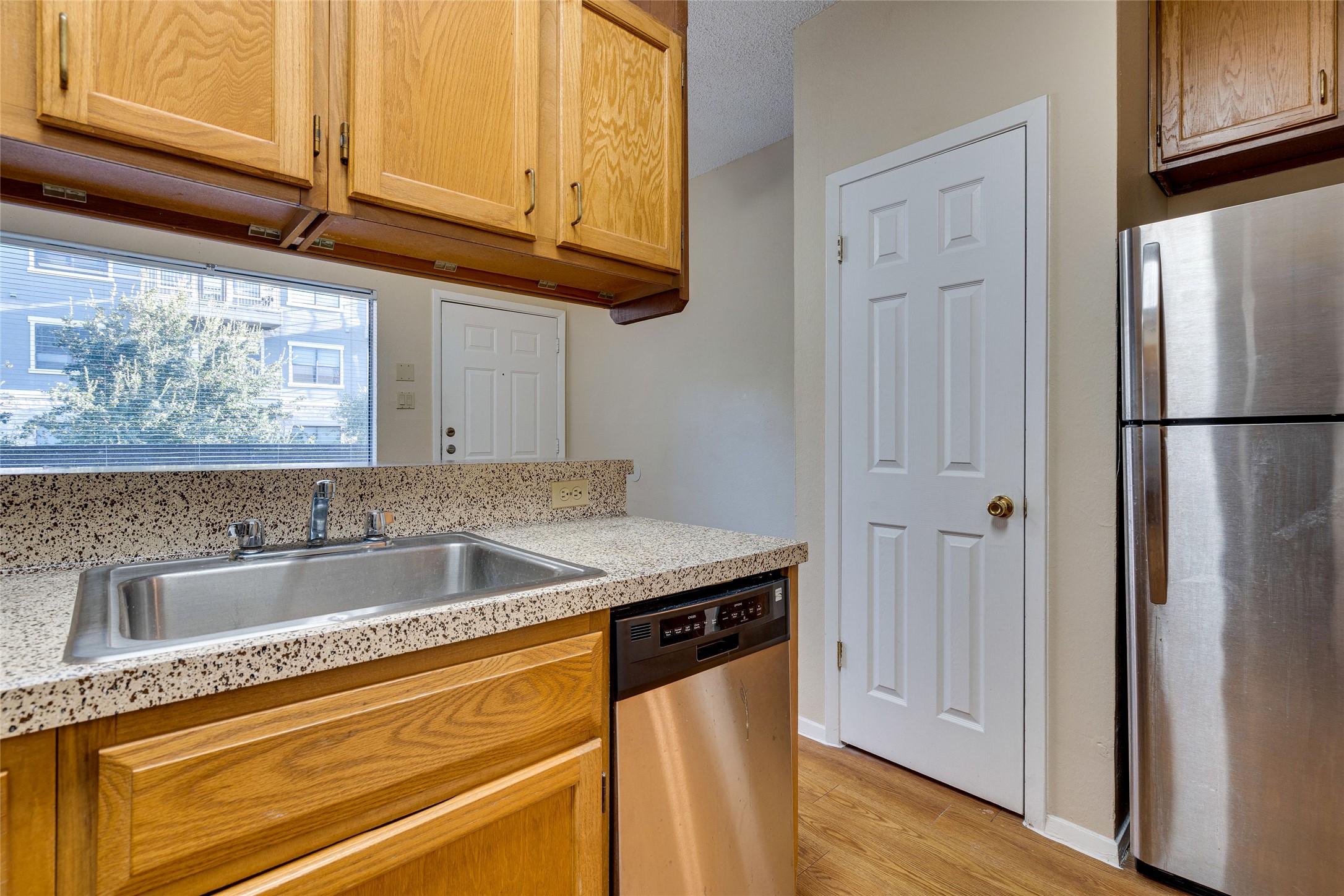 2210 Pearl Street, Unit 203 Austin, TX 78705 - Photo 14 of 22 a view white cabinets and a wooden floor