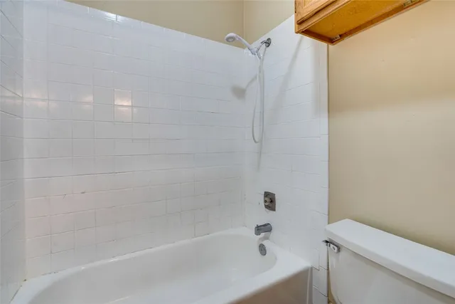 a bathroom with a bathtub and a toilet