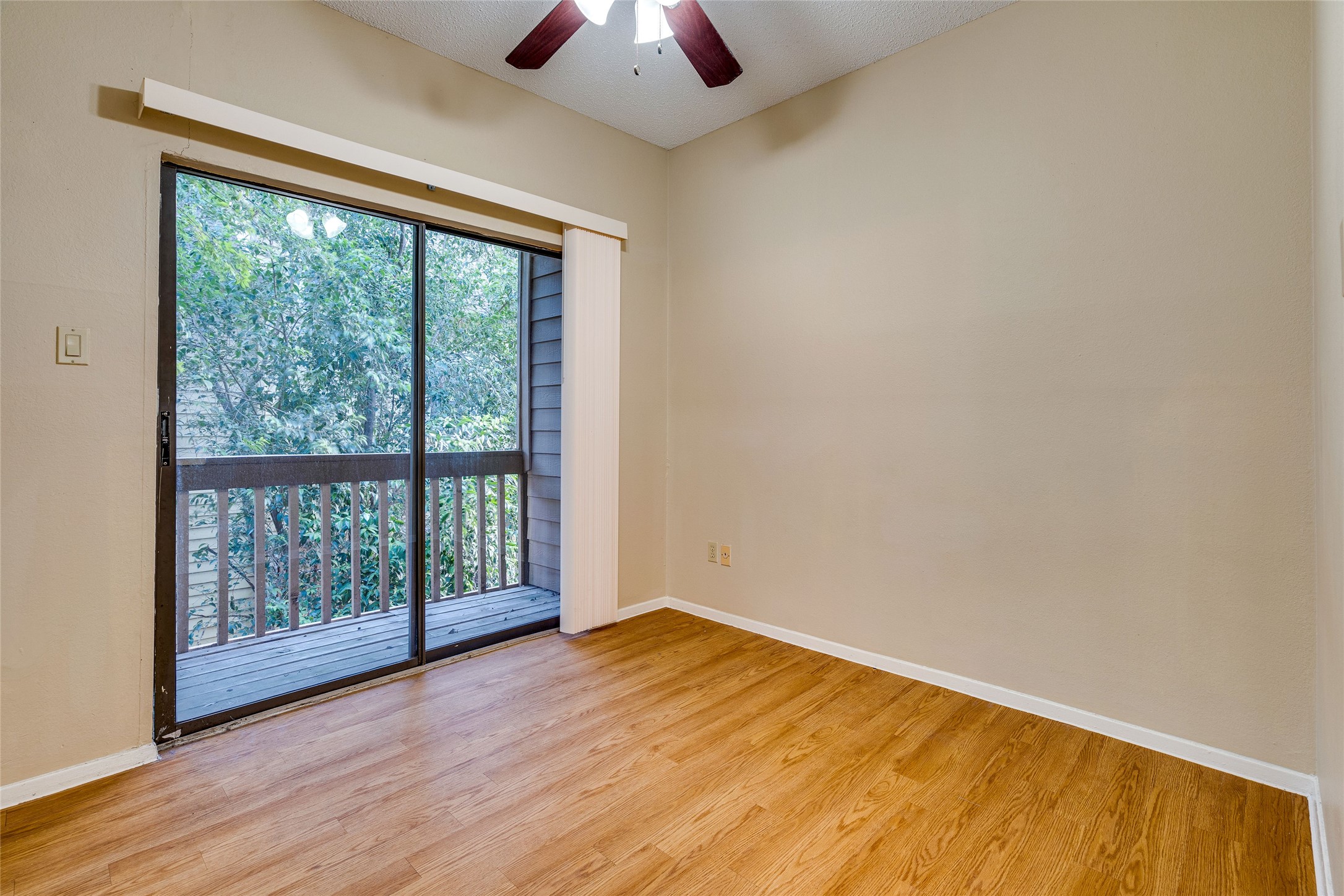 2210 Pearl Street, Unit 203 Austin, TX 78705 - Photo 18 of 22 wooden floor in an empty room with a window