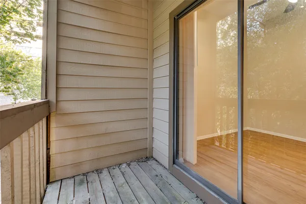 a view of a balcony with wooden floor