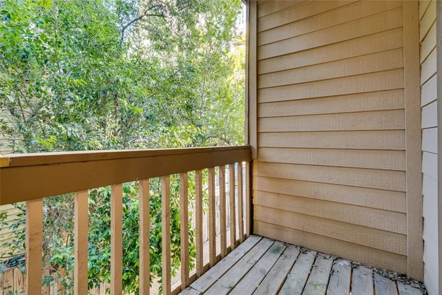 a view of a balcony with wooden floor