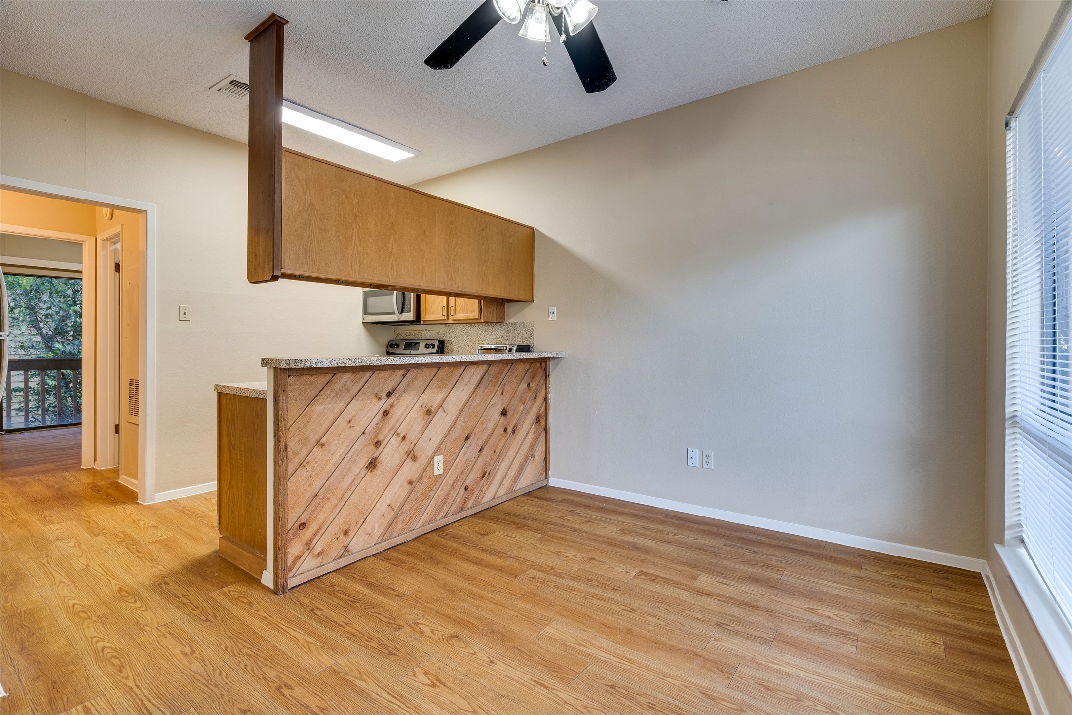 2210 Pearl Street, Unit 203 Austin, TX 78705 - Photo 5 of 22 a view of room with window and wooden floor