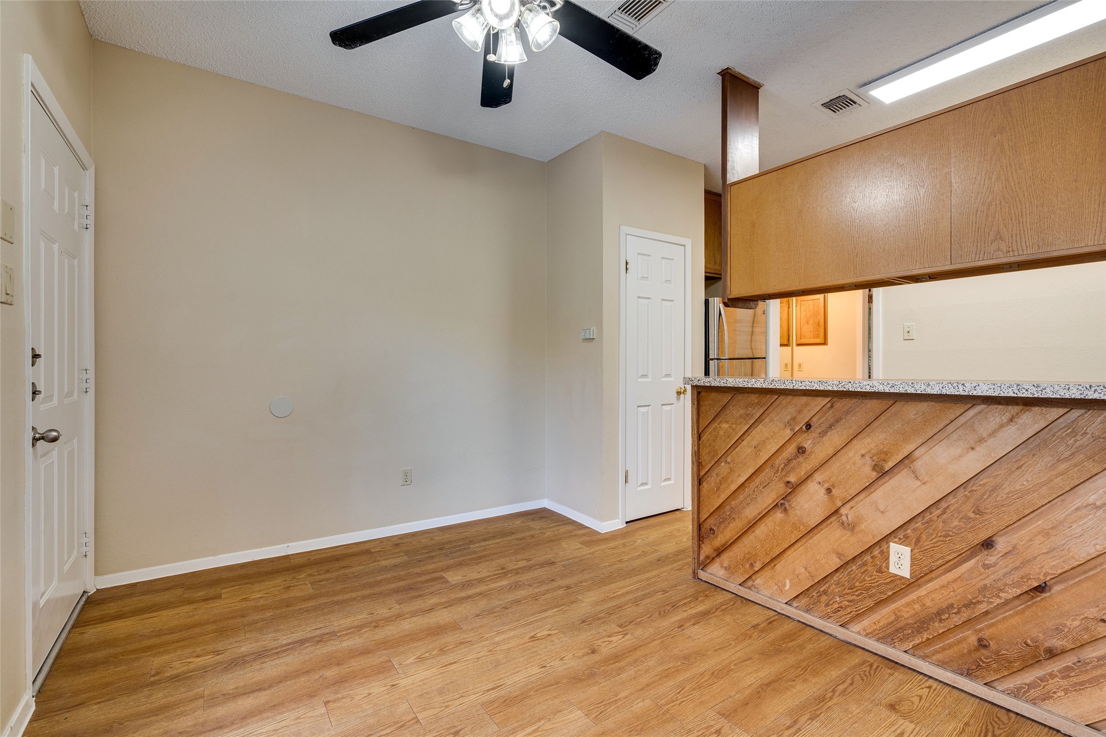2210 Pearl Street, Unit 203 Austin, TX 78705 - Photo 6 of 22 an empty room with wooden floor chandelier fan and windows
